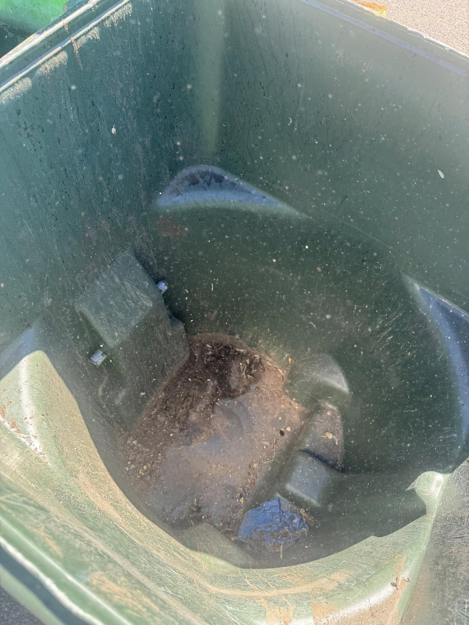 A second Pocatello trash can caked with grime before cleaning